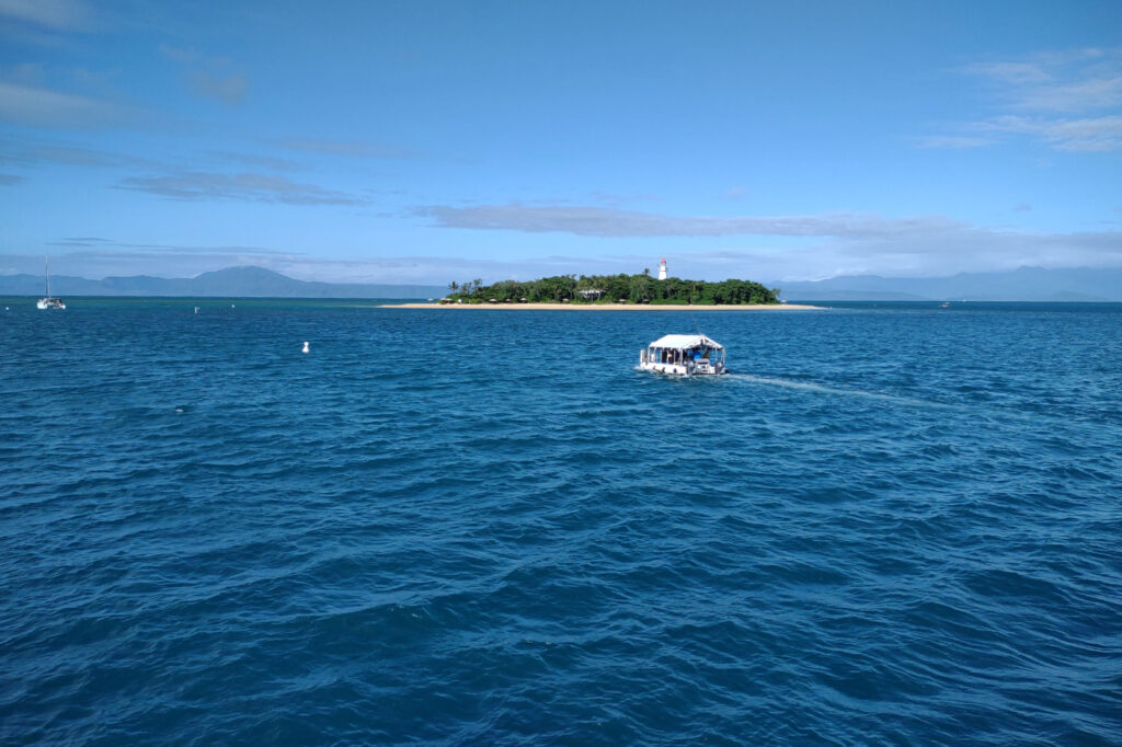 Glass bottom boat approaching an island