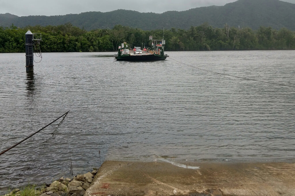 The Daintree Ferry on a wet cloudy day. Cars crossing the Daintree River.
