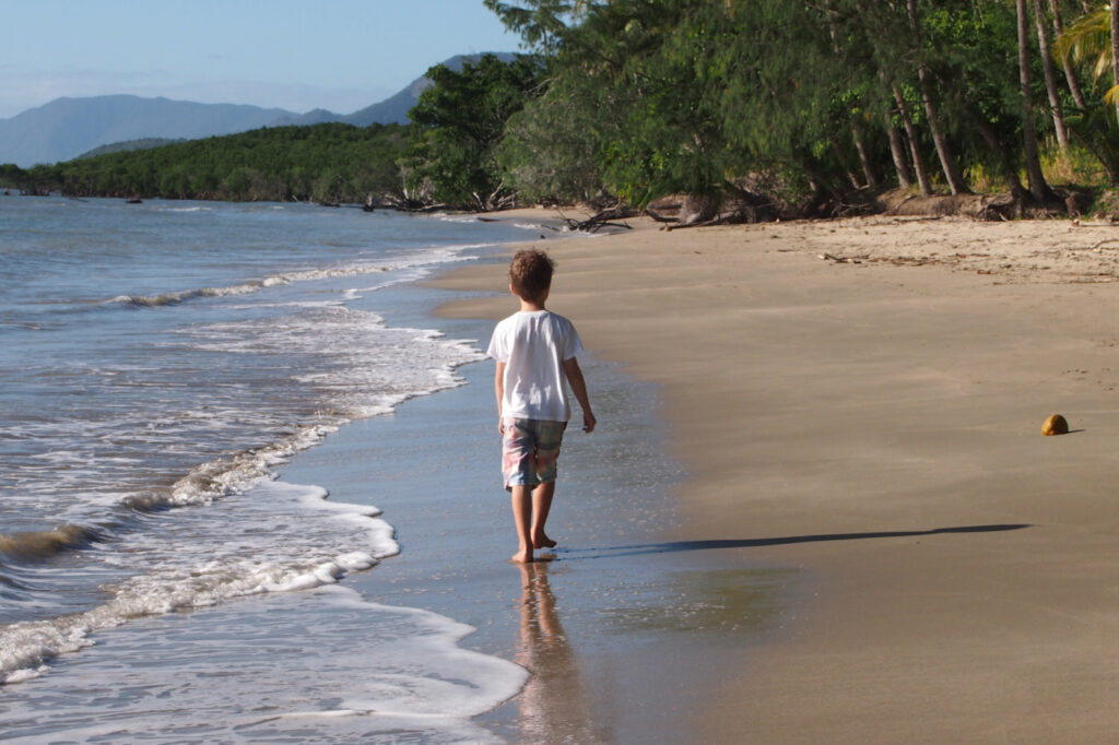 A child walking on Port Douglas Beach.