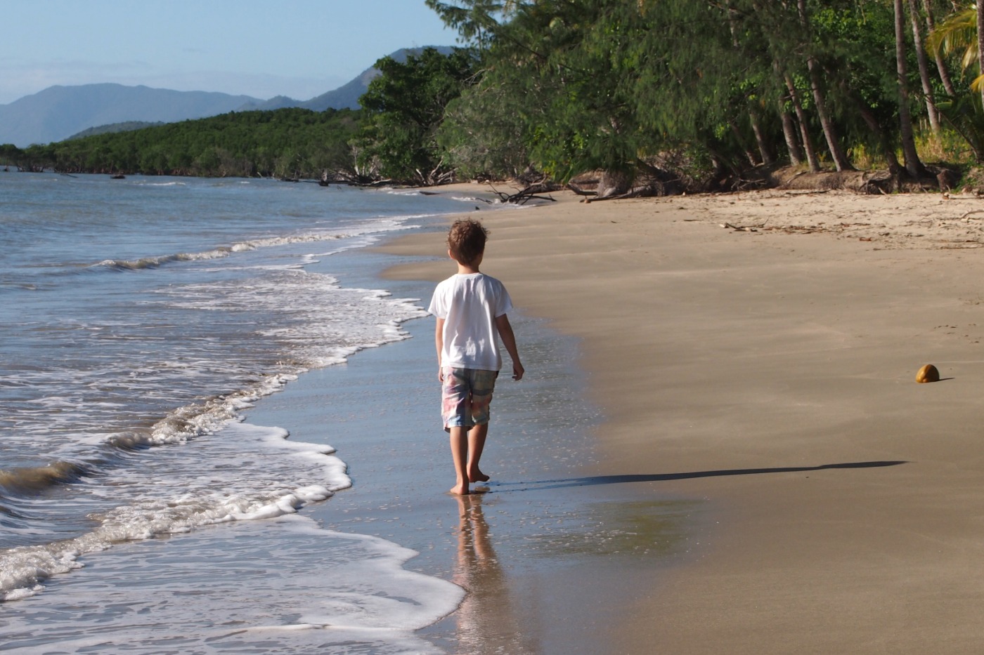 A child walking on Port Douglas Beach.